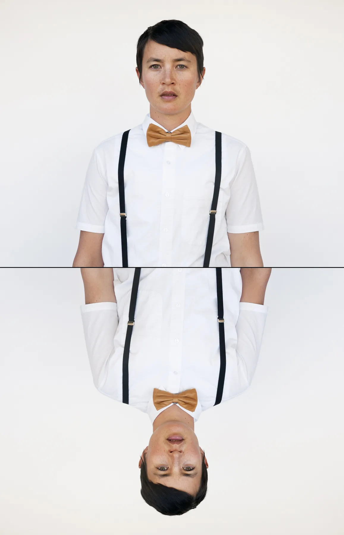 An individual's profile staring at the camera and their mirror image reversed, wearing a brown bowtie and suspenders. 